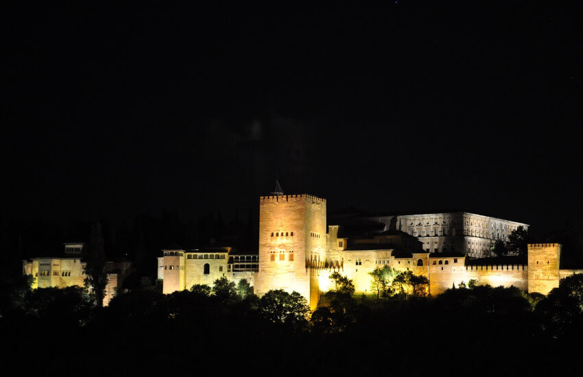 Beleuchtete Burg aus Stein in der Nacht fotografiert.